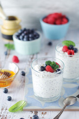 Greek yogurt in glasses with berries and quinoa