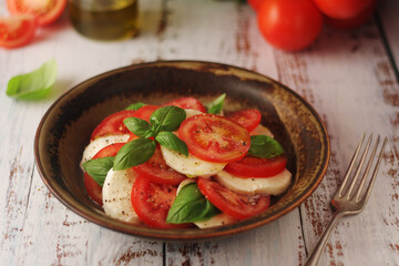 A bowl with traditional Italian caprese salad	