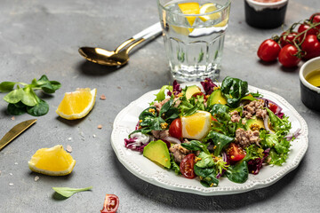 Close up tuna salad with lettuce, cherry tomatoes, avocado and red onions. superfood concept. Healthy, clean eating concept. Vegan or gluten free diet. Top view