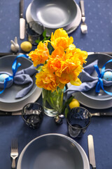Vase with beautiful tulips on table served for Easter celebration