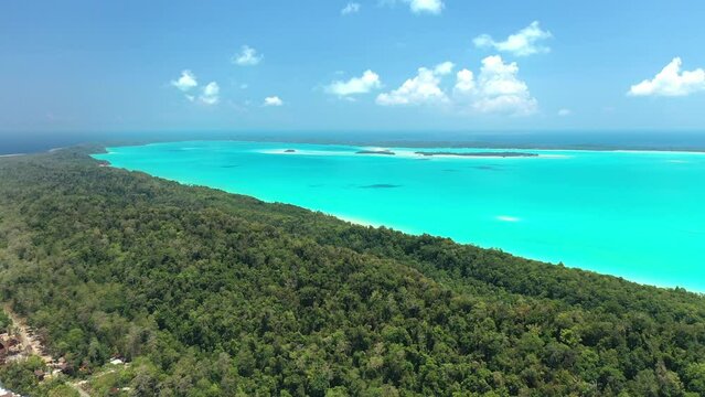 Drone view of surroundings on a tropical island, turquoise lagoon , coral reef , and deep blue see