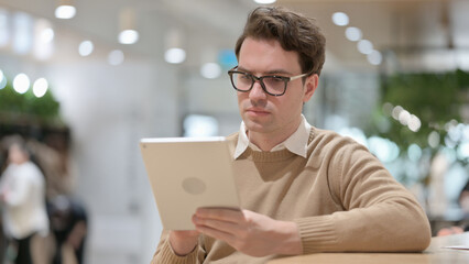 Portrait of Young Man using Tablet in Office 