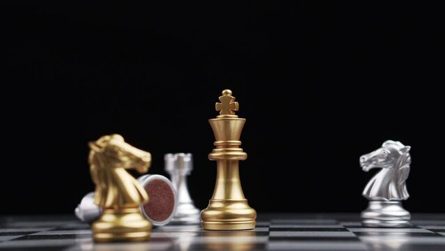 Close up of male hand moving gold king chess for defeating opponent, Game of Chess. Leader and Teamwork Concept for Success. Business Solutions, Success Strategy.