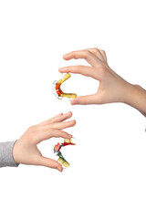 Two children's hands with orthodontic appliances on a white background. The concept of oral hygiene in childhood.