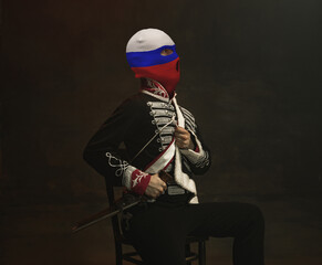 Portrait in mixed style. Young men, medieval hussar wearing red, blue and white colors balaclava on...
