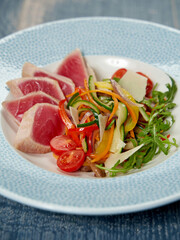 rare seared Ahi tuna slices with fresh vegetable salad