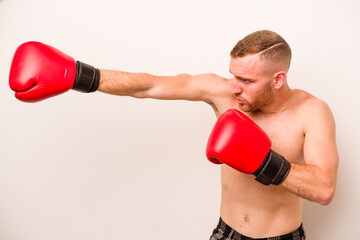 Young caucasian man doing boxing isolated on white background