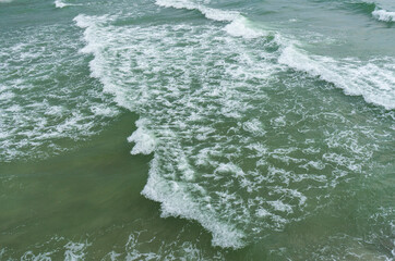 high angle view of small waves near the coast can see the turbidity of the sea