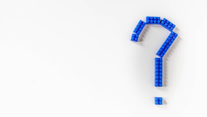 Blue question mark  design from toy puzzle on white background
