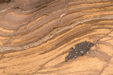 Rock surface showing different strata. Montana Clara. Integral Natural Reserve of Los Islotes. Canary Islands. Spain.