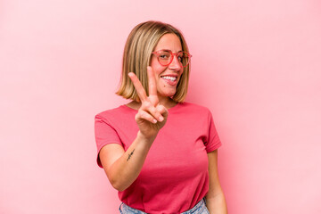 Young caucasian woman isolated on pink background showing number two with fingers.