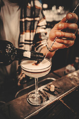 man hand bartender making cocktail in glass on the bar counter