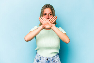 Young caucasian woman isolated on blue background doing a denial gesture