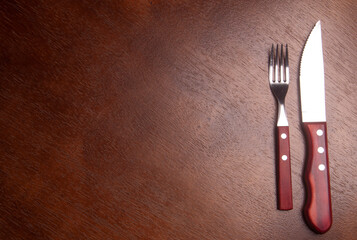 empty wood table with fork and knife - hungry