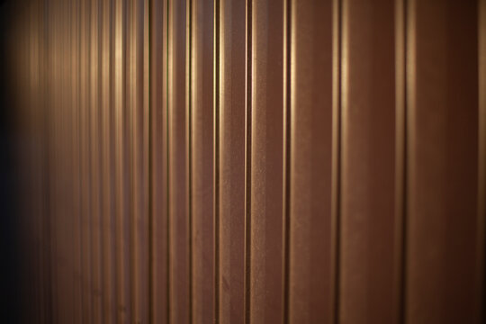 Texture of steel fence. Profile sheet is brown. Fence details.