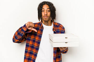 Young African American man holding pizzas isolated on blue background showing a dislike gesture,...