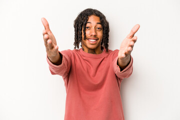 Young African American man isolated on white background feels confident giving a hug to the camera.