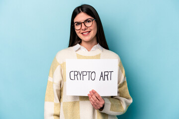 Fototapeta na wymiar Young caucasian business woman holding a crypto art placard isolated on blue background laughing and having fun.