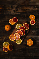 Top view of cutting board with slices of blood orange, orange and lemon on table