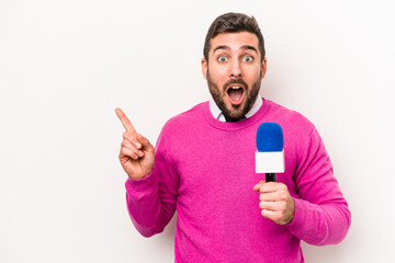 Young caucasian tv presenter man isolated on white background pointing to the side