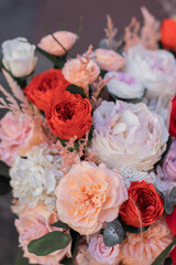 Red rose and peach peonies in a big round box for mother's day, valentine's day, Woman's day 8 march.