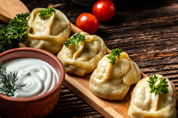 Traditional manti food on plate, top view. The concept of oriental cuisine. Uzbek food manty dumplings. Uzbek food. banner, catering menu recipe place for text