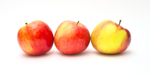 Three apples on an isolated white background. Panoramic photography.