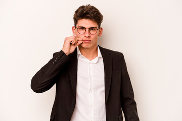 Young caucasian business man isolated on white background with fingers on lips keeping a secret.