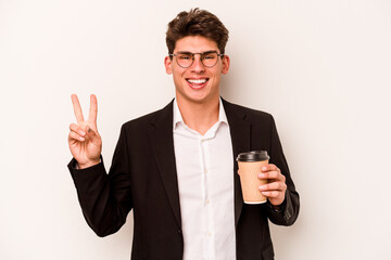 Young caucasian business man holding takeaway coffee isolated on white background joyful and carefree showing a peace symbol with fingers.