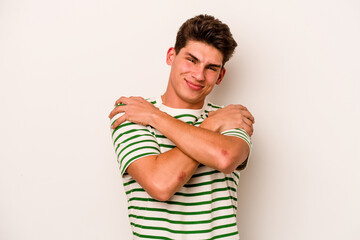 Young caucasian man isolated on white background hugs, smiling carefree and happy.