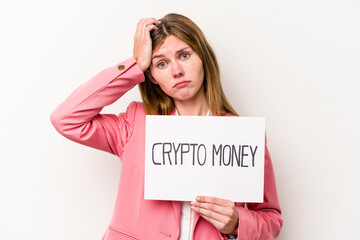 Young English business woman holding a crypto money placard isolated on white background being shocked, she has remembered important meeting.