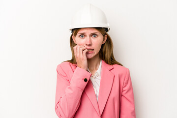 Young architect English woman with helmet isolated on white background biting fingernails, nervous and very anxious.