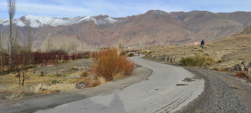 Panoramic view of a road heading to the gray mountains under the clear sky in Morocco