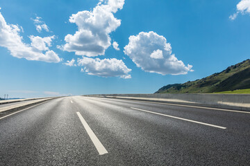 Asphalt roads and mountains with sky cloud background