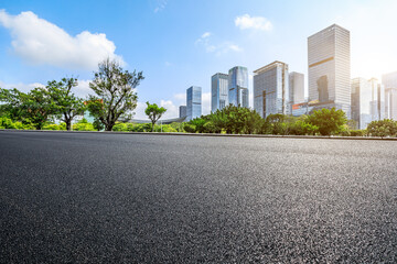 Asphalt road and city skyline with modern commercial buildings in Shenzhen, China.