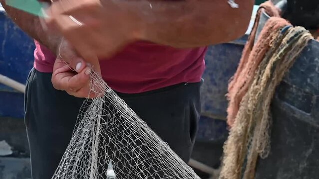 fisherman fixing the fishing net italian white man european italy  amalfi coast sorrento - manual work