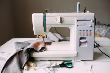 Sewing machine, accessories and fabric. Cozy creative sewing process at home
