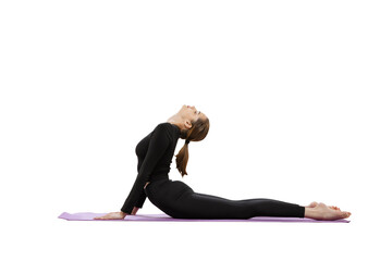 Portrait of young slim woman doing yoga on sport mat, stretching back with exercises isolated over white studio background