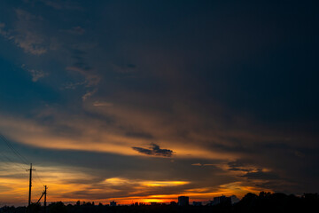 Natural Sunset Sunrise Over Field Or Meadow. Bright Dramatic Sky And Dark Ground. Countryside Landscape Under Scenic Colorful Sky At Sunset Dawn Sunrise. Sun Over Skyline, Horizon. Warm Colours