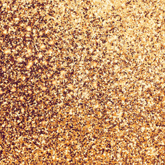 Detailed texture of glittering golden dust surface. Background filled with shiny gold glitter