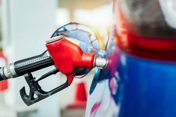 Car fueling at gas station. Refuel fill up with petrol gasoline. Petrol pump filling fuel nozzle in fuel tank of car at gas station. Petrol industry and service. Petrol price and oil crisis concept.