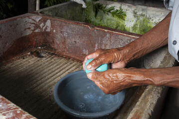 Coronavirus prevention, covid 19 in rural Guatemala, man washing hands,