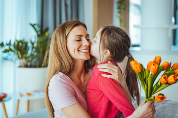 Child congratulates mother and gives a bouquet of flowers to tulips. Happy mother's day! Child...