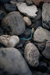 Plastic rope on the rocky beach in France.