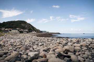 Fototapeta na wymiar Rocks and stones on the beach in Normandy, France.