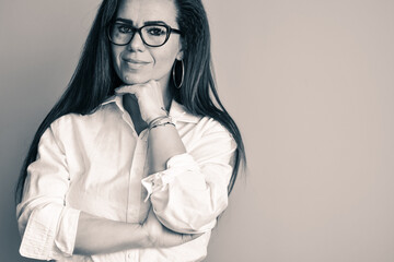   Studio  Black and white Portrait of Beautiful  smiling Business Woman  .Young attractive woman presenting business strategy  for cryptocurrency company 