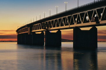 Fototapeta na wymiar The Oresund Bridge between Denmark and Sweden at sunset