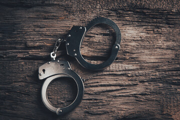 closeup of handcuffs on obscure stainless steel