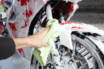 cleaning red sportbike in the car wash