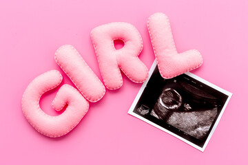 Baby girl. Prenatal ultrasound screening of unborn baby with letters girl